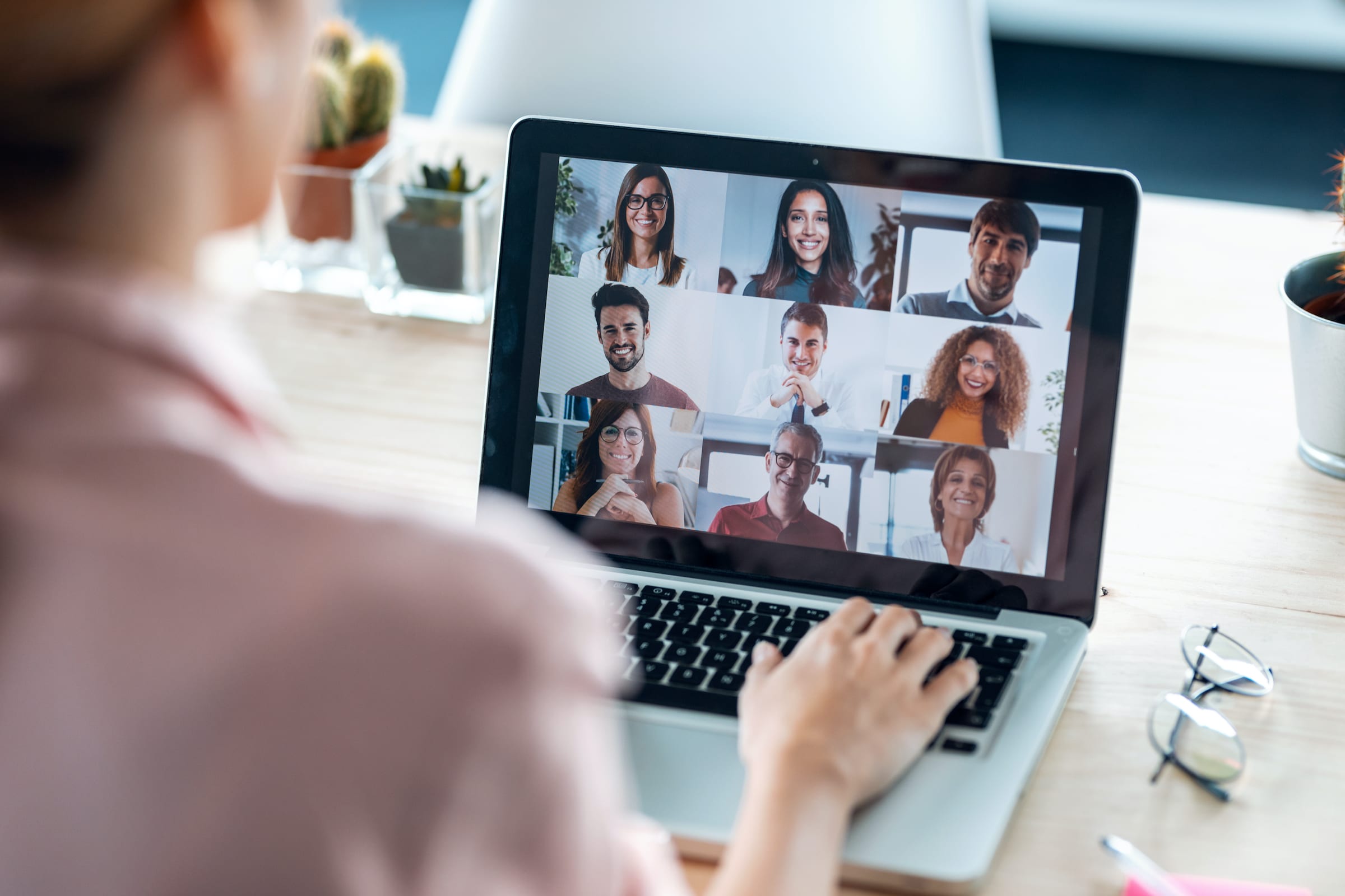 A remote team member meeting with nine others on a video conference call