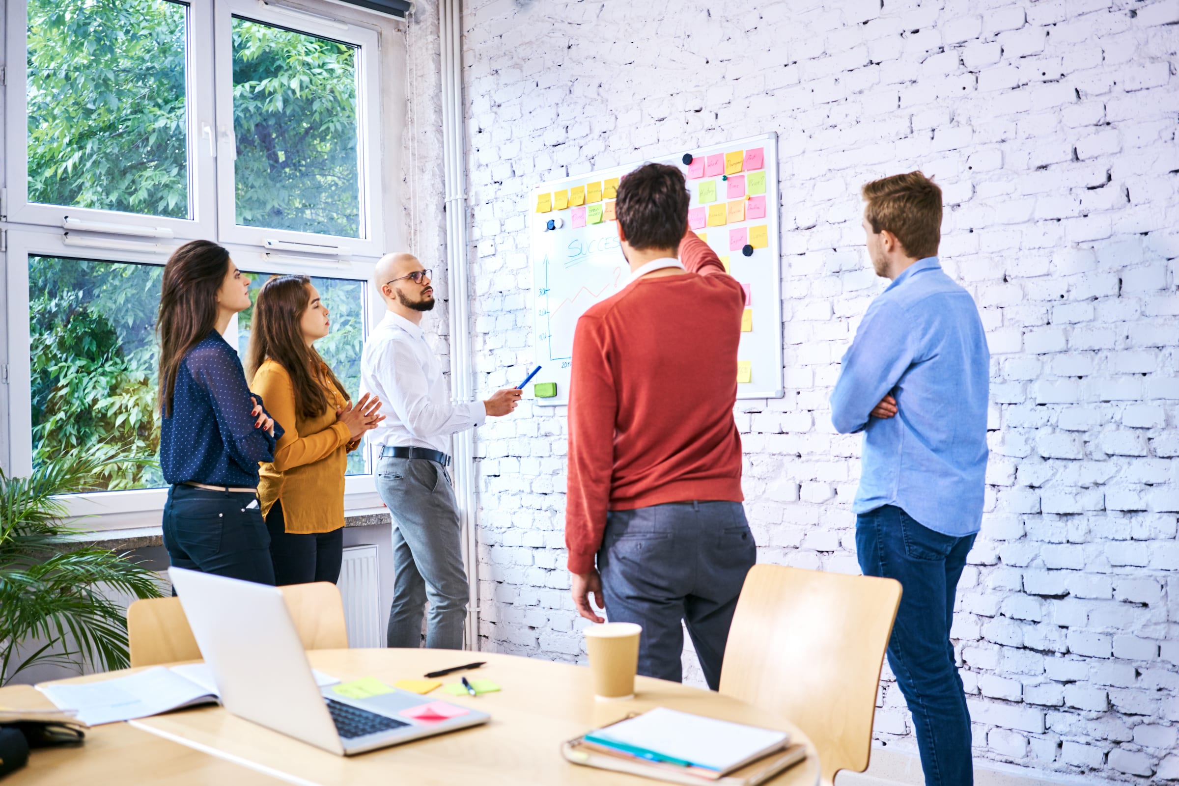 A group of UX designers, developers, scrum masters, and product owners attending a SAFe training workshop