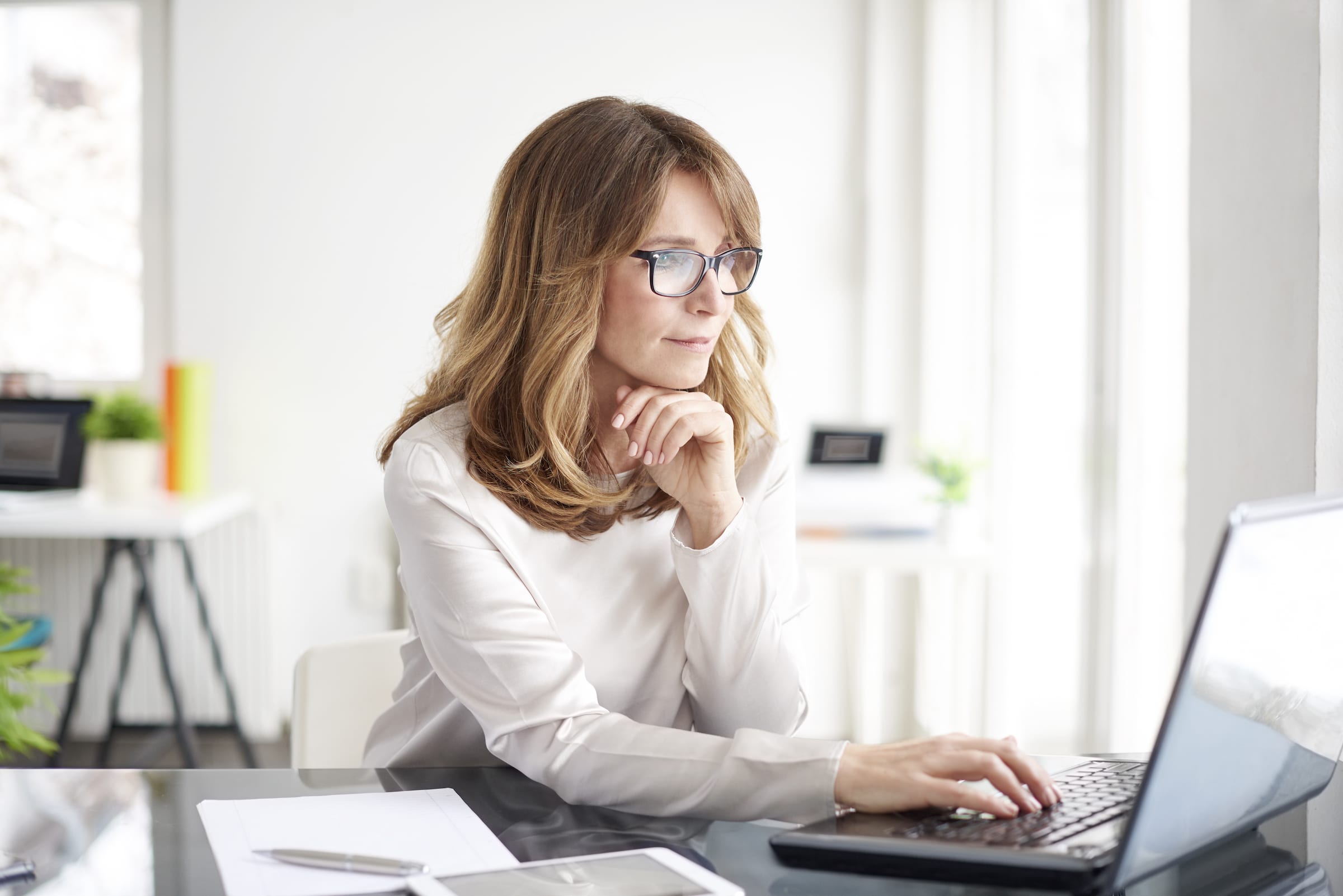 Woman sitting at a desk with laptop open