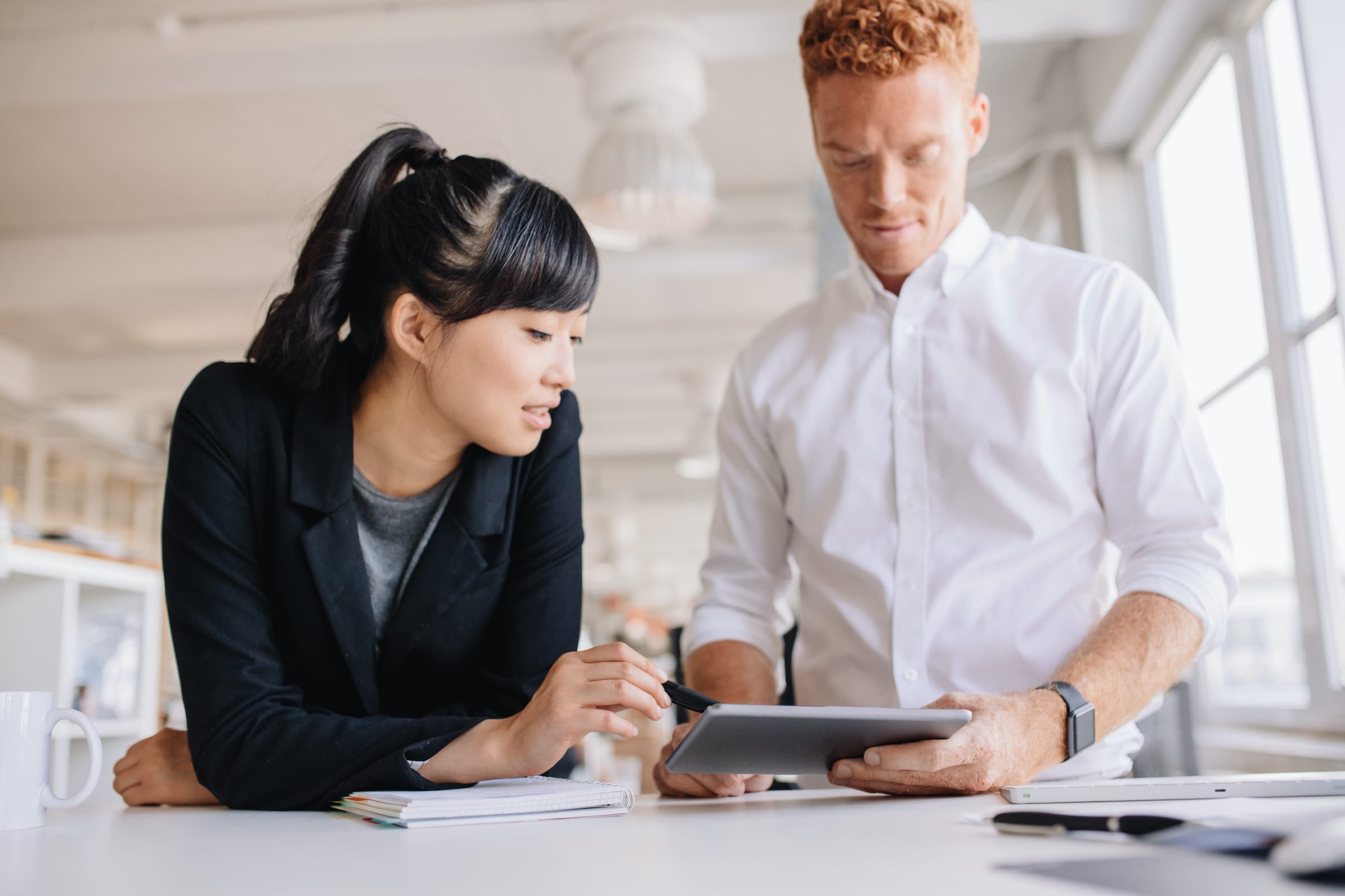 A Ventera team member using a tablet to show a client how Ventera Test Automation Framework better supports Agile and DevOps