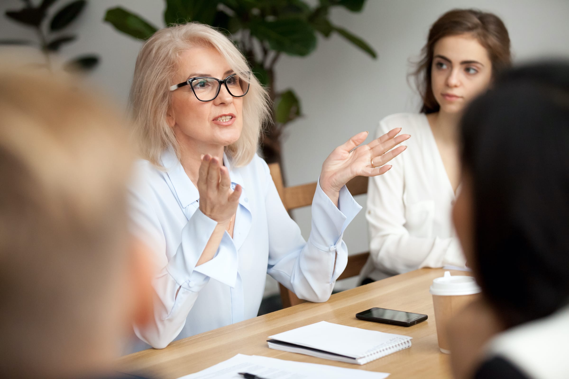 Woman leading a meeting at a conference table
